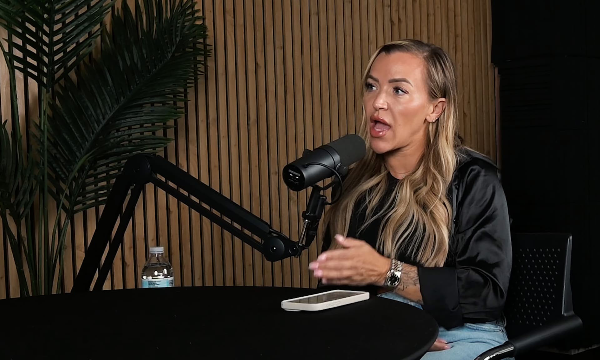 Guest at the Shure SM7B microphone with wood panel backdrop